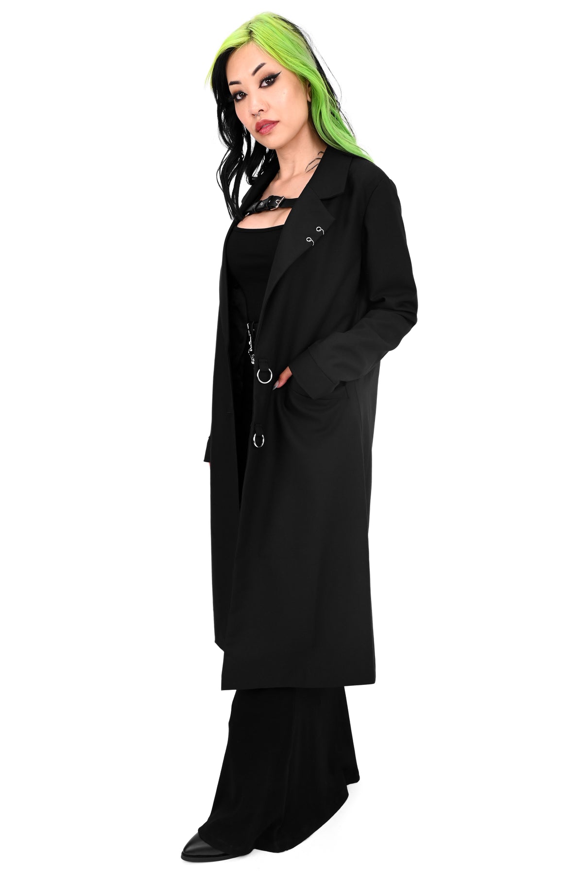 Long black trench coat with two o-ring piercing details on the left lapel