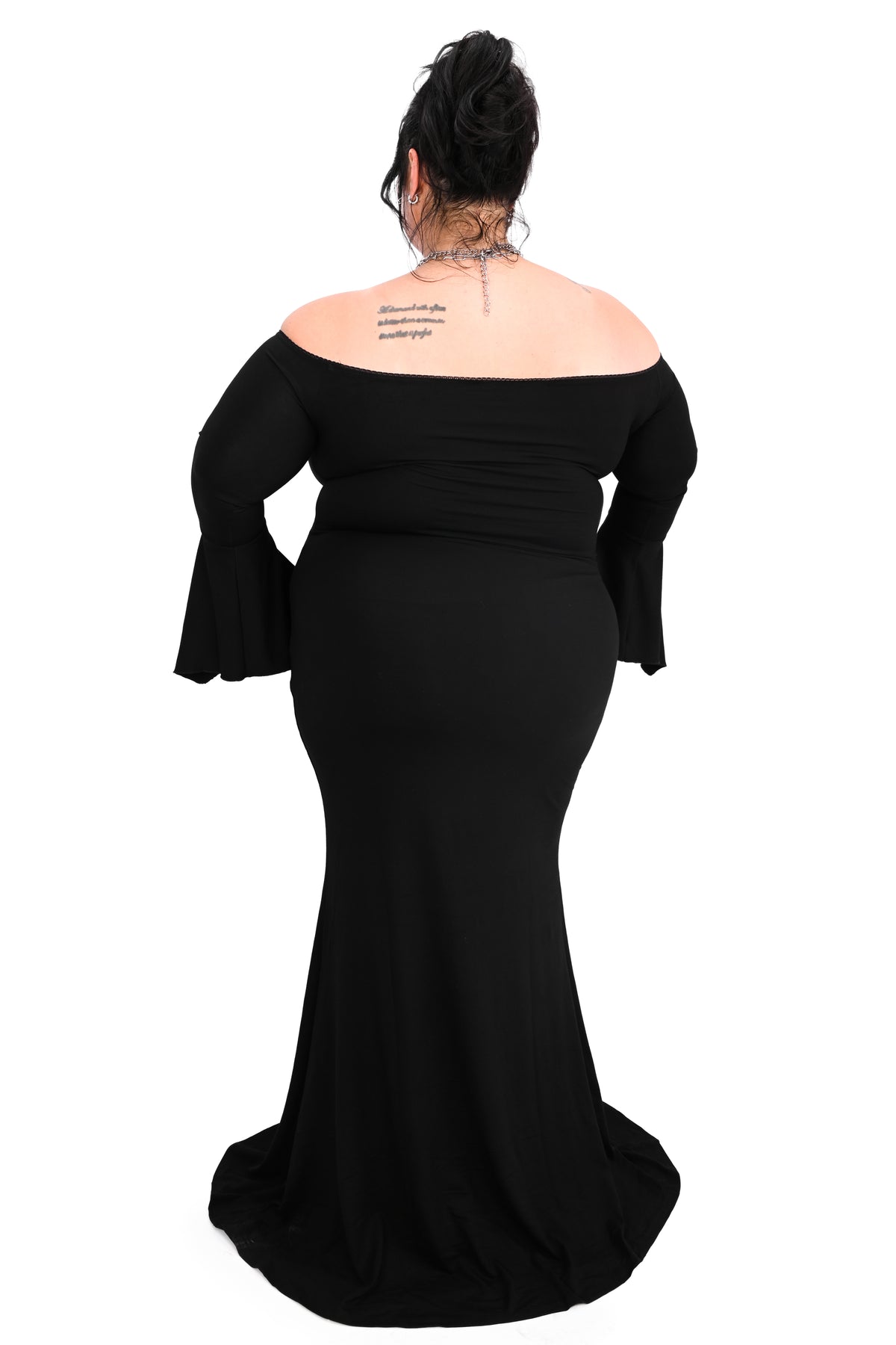 black bell sleeve off the shoulder maxi dress with flared bottom and dagger pendant in the middle of the neckline