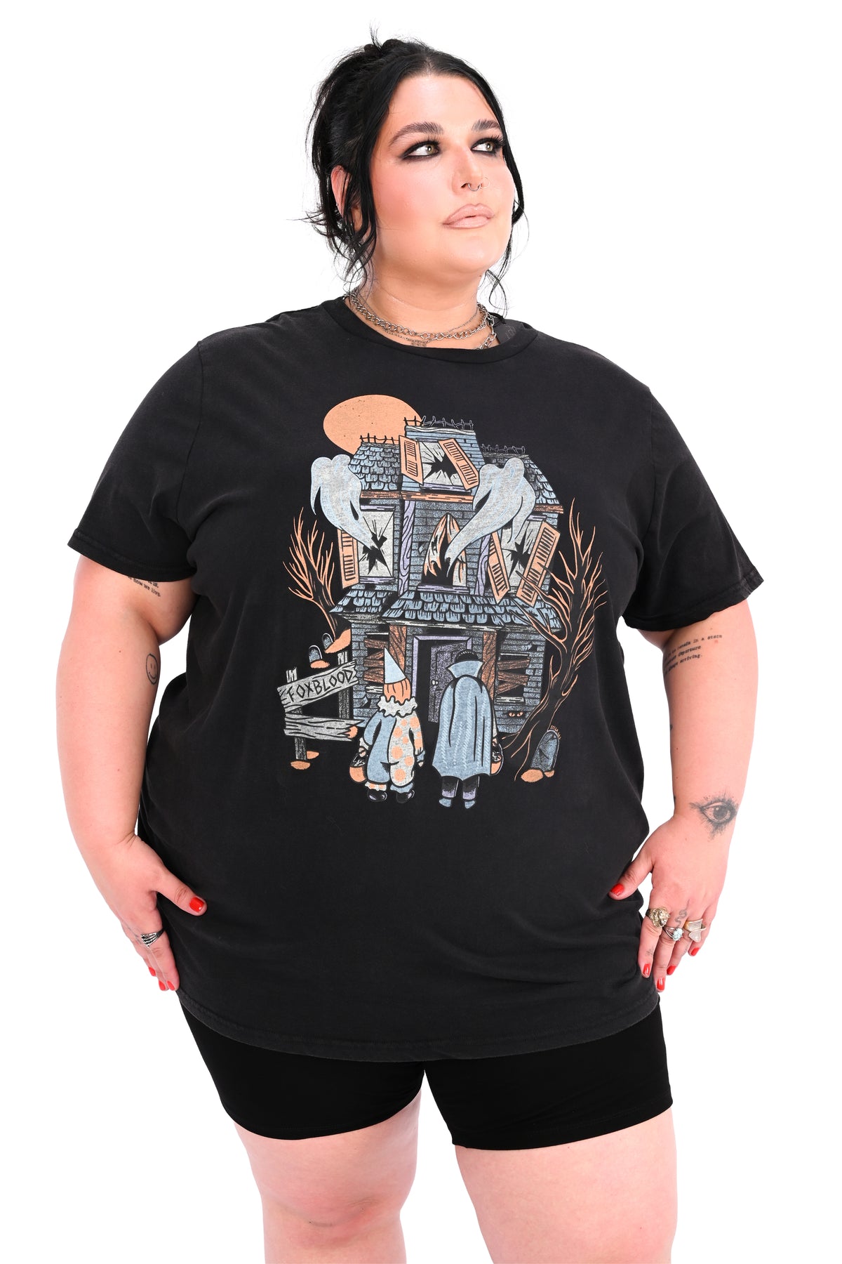 vintage black tee feature a haunted house with ghosts and two trick or treaters