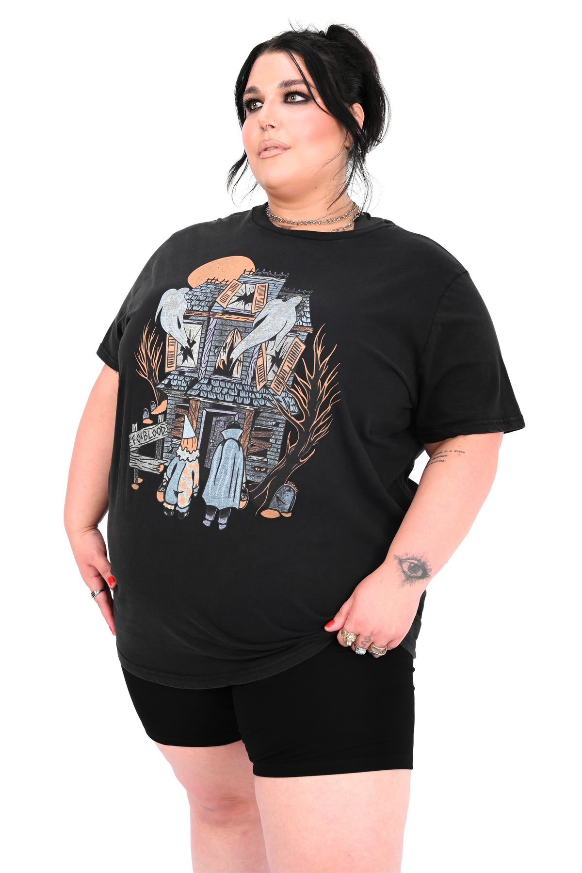vintage black tee feature a haunted house with ghosts and two trick or treaters