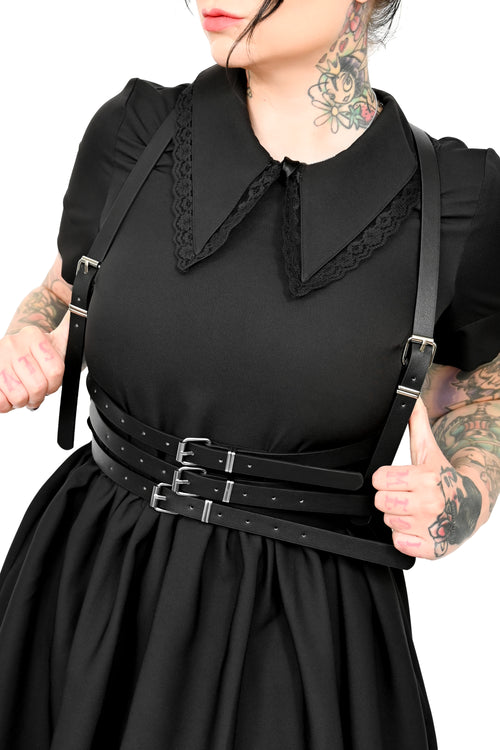Black vegan leather harness with 3 adjustable front buckles, 2 adjustable straps, and a Y style back with O ring.