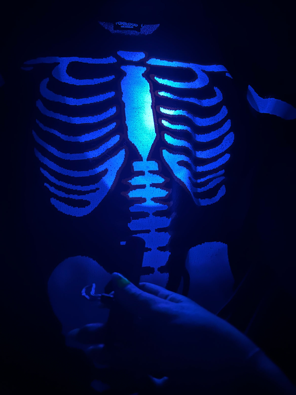 uv flashlight shown on glow in the dark skeleton print