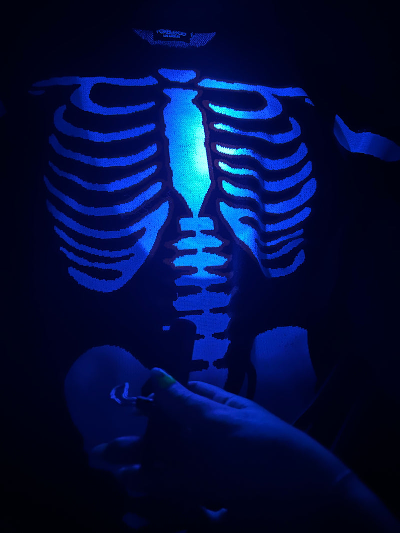 uv flashlight shown on glow in the dark skeleton print