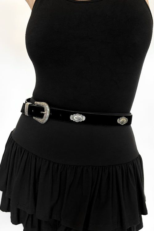 black flocked faux leather belt with silver western-style pendants and buckle