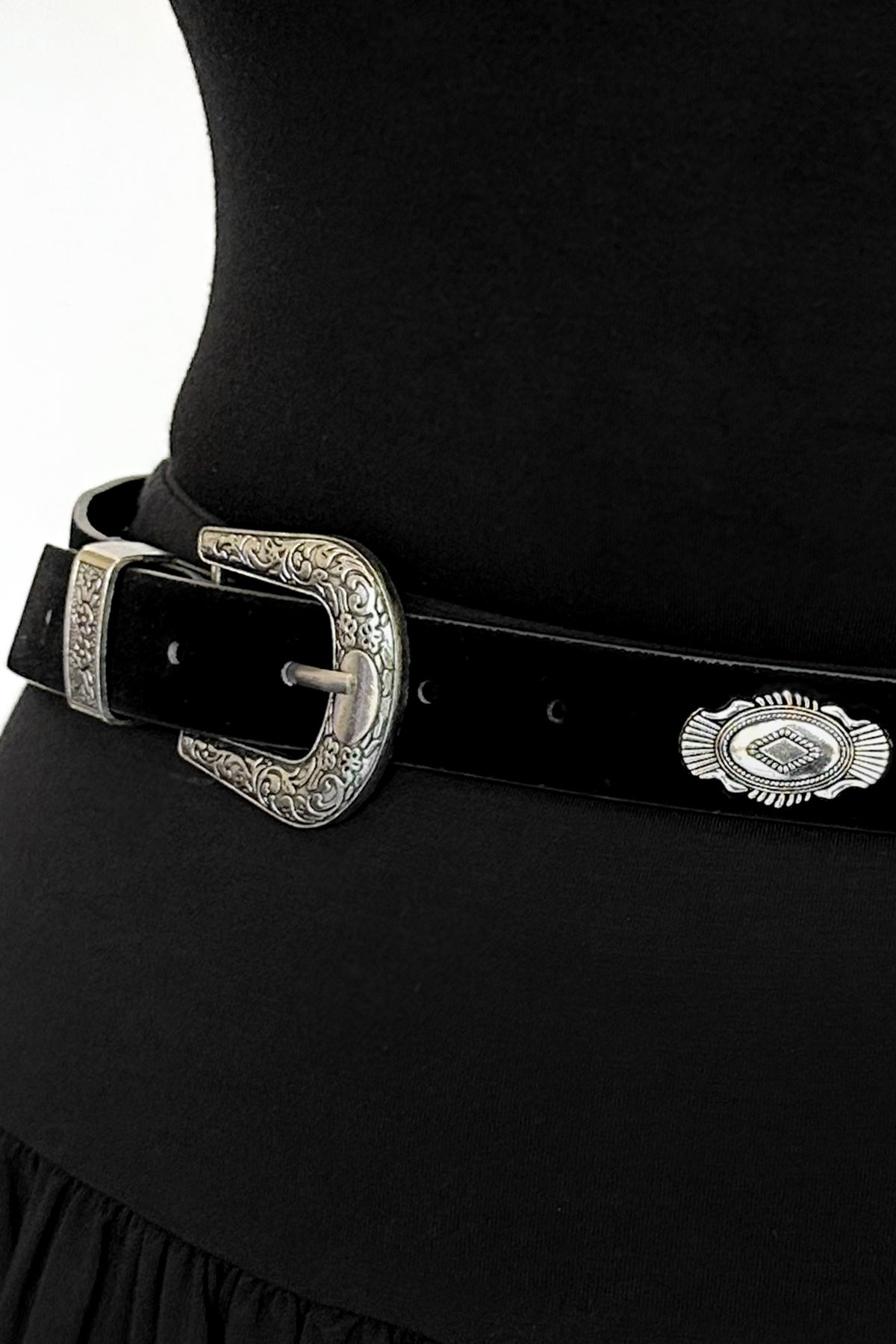 black flocked faux leather belt with silver western-style pendants and buckle