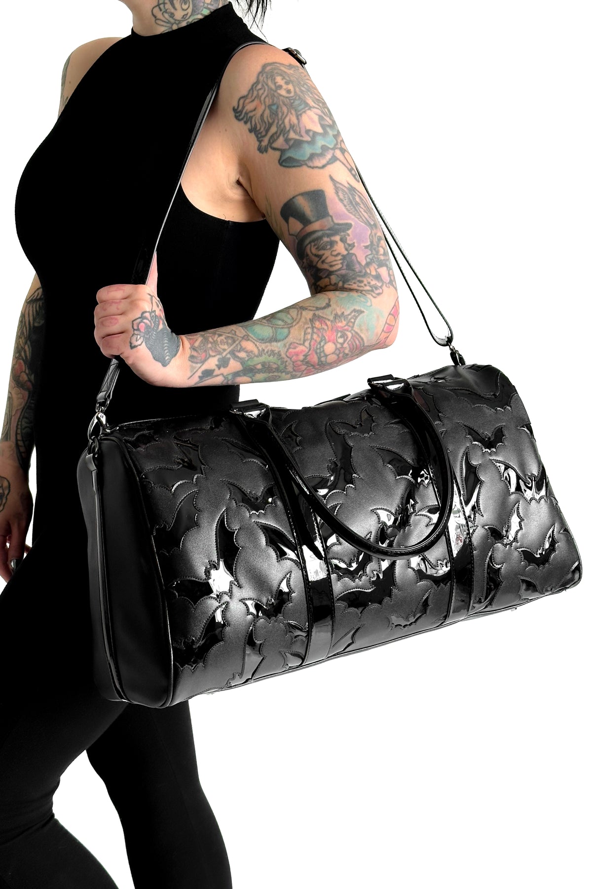 black faux leather weekender duffel bag with black patent bats all over