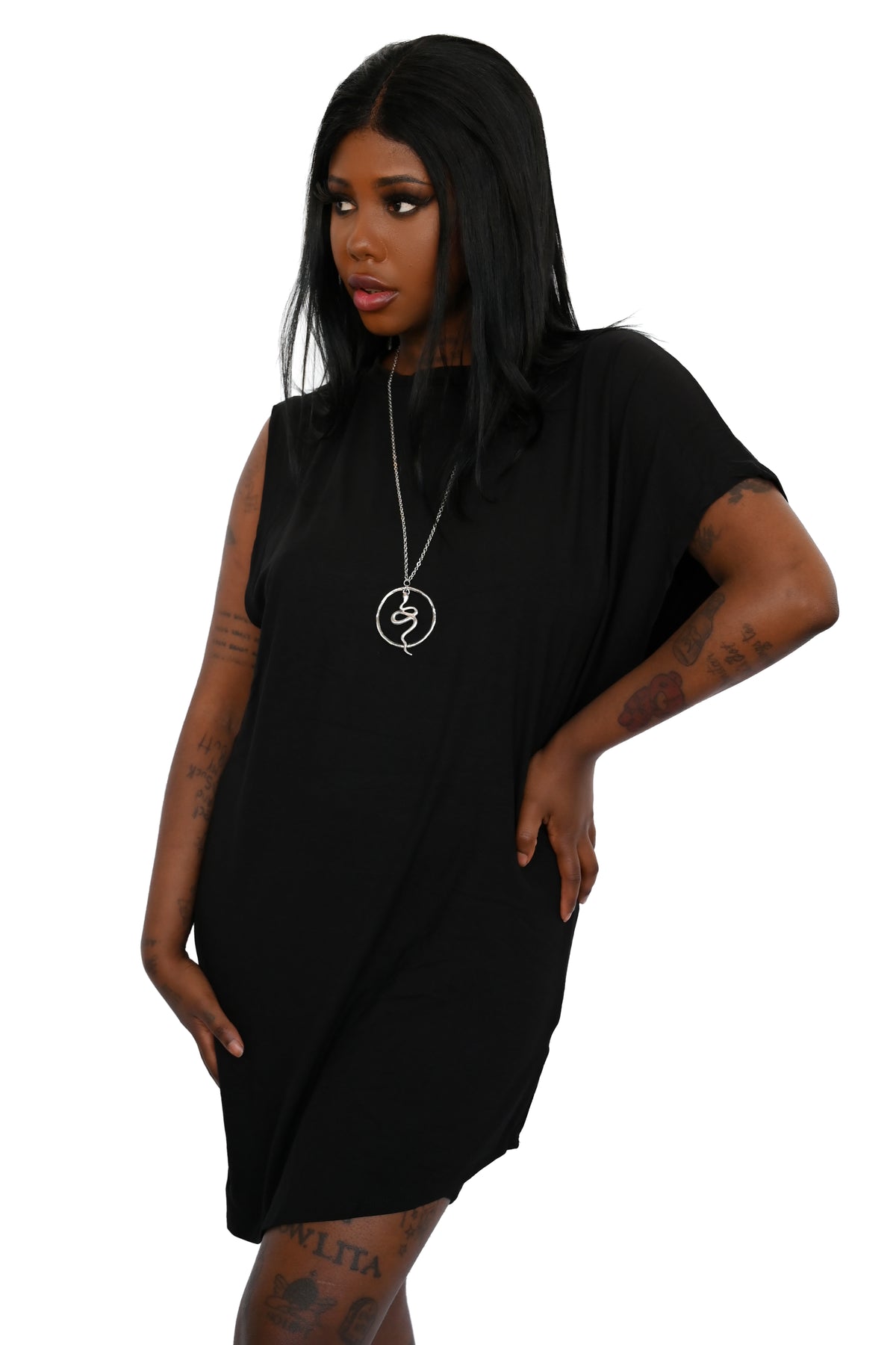 Model is wearing a black longline symmetrical tunic. It has a left sleeve and the right side is sleeveless