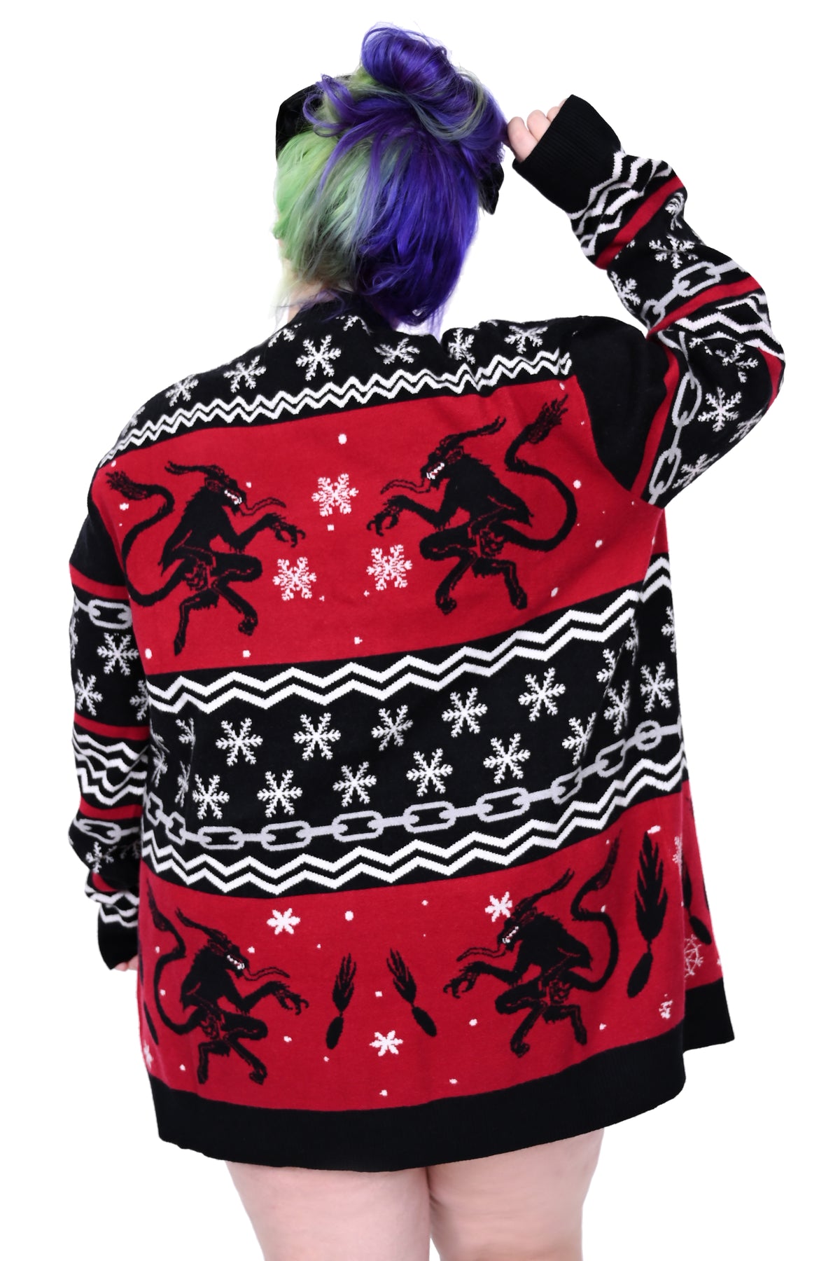 a spooky twist on a classic sweater pattern, featuring snowflakes, chains, and the creepiest Krampus silhouette with his broom.