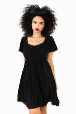 above the knee black dress with lace trim on cuff sleeve, neckline and bottom hem 