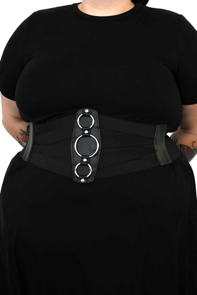 A full elastic belt with 3 metal ring detailing on the front of the waist.   Elastic back with 3 snap closure.  