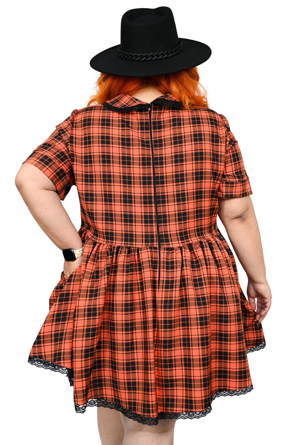 This orange plaid swing dress has a pointed collar with lace trim, and the same trim on the bottom hem. Under the collar there is an adjustable ribbon. Zipper on the back