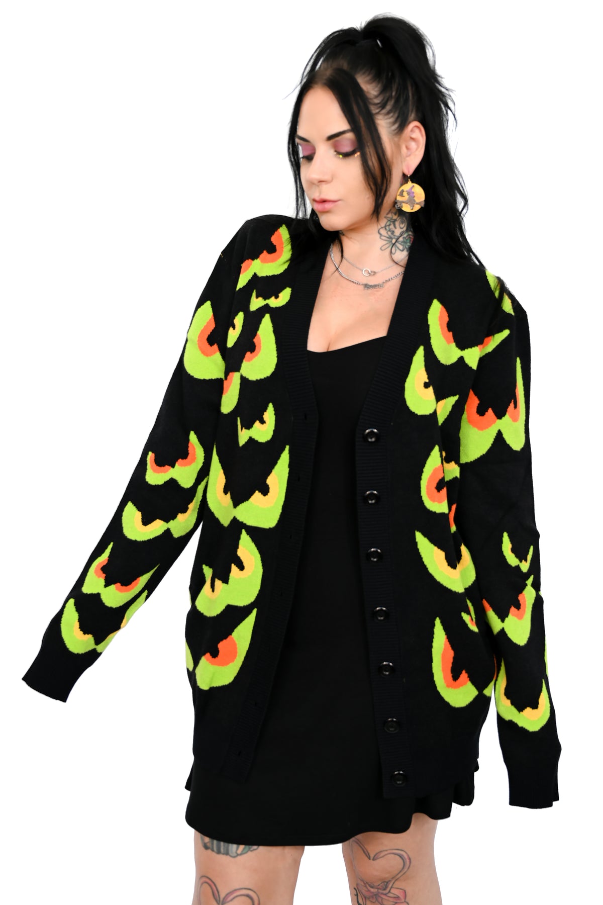 black cardigan with green/yellow and green/orange spooky eyes all over
