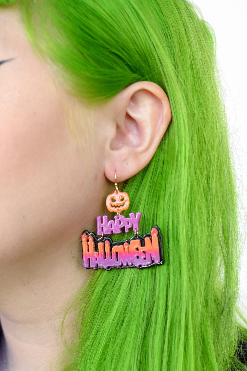 Dangling Halloween earrings with melted candle text and lil pumpkins.