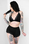black triangle bralette with lace trim and black shorts with lace trim 