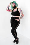 black crop top with net detailing on sides and black joggers with pockets, a drawstring waist and net detailing on sides 