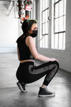 black crop top with net detailing on sides and black joggers with drawstring waist and net detailing on sides 