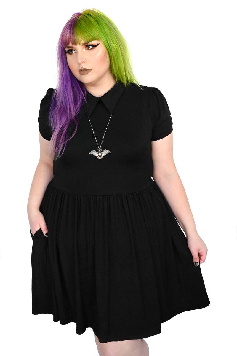 Black collared swing dress with pockets and tie back