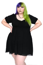 above the knee black dress with lace trim on cuff sleeve, neckline and bottom hem