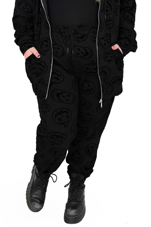 black drawstring joggers with flocked jackolantern face pattern