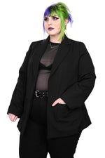 Sleek black blazer. Long Lined and slightly oversized, with generous outside pockets.