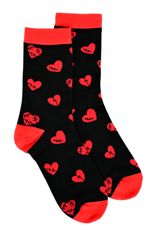 black 100% cotton socks with red cuff, heel, and toe and red broken hearts all over