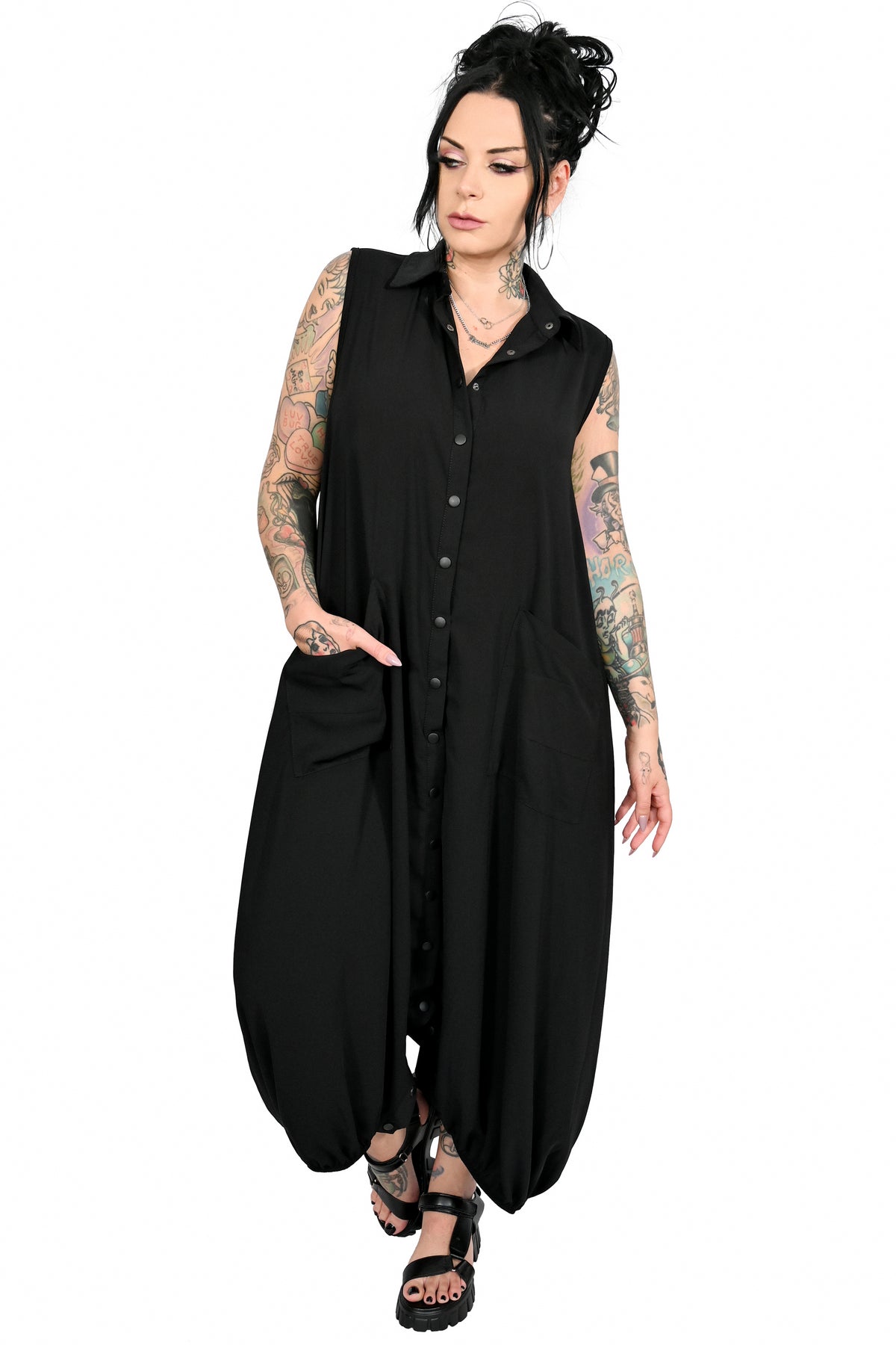 Button down jumpsuit with snaps and front pockets. unbutton the bottom to wear as a flowing maxi!