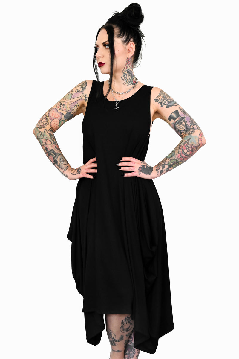 black sleeveless dress with a scoop neck and asymmetrical skirt