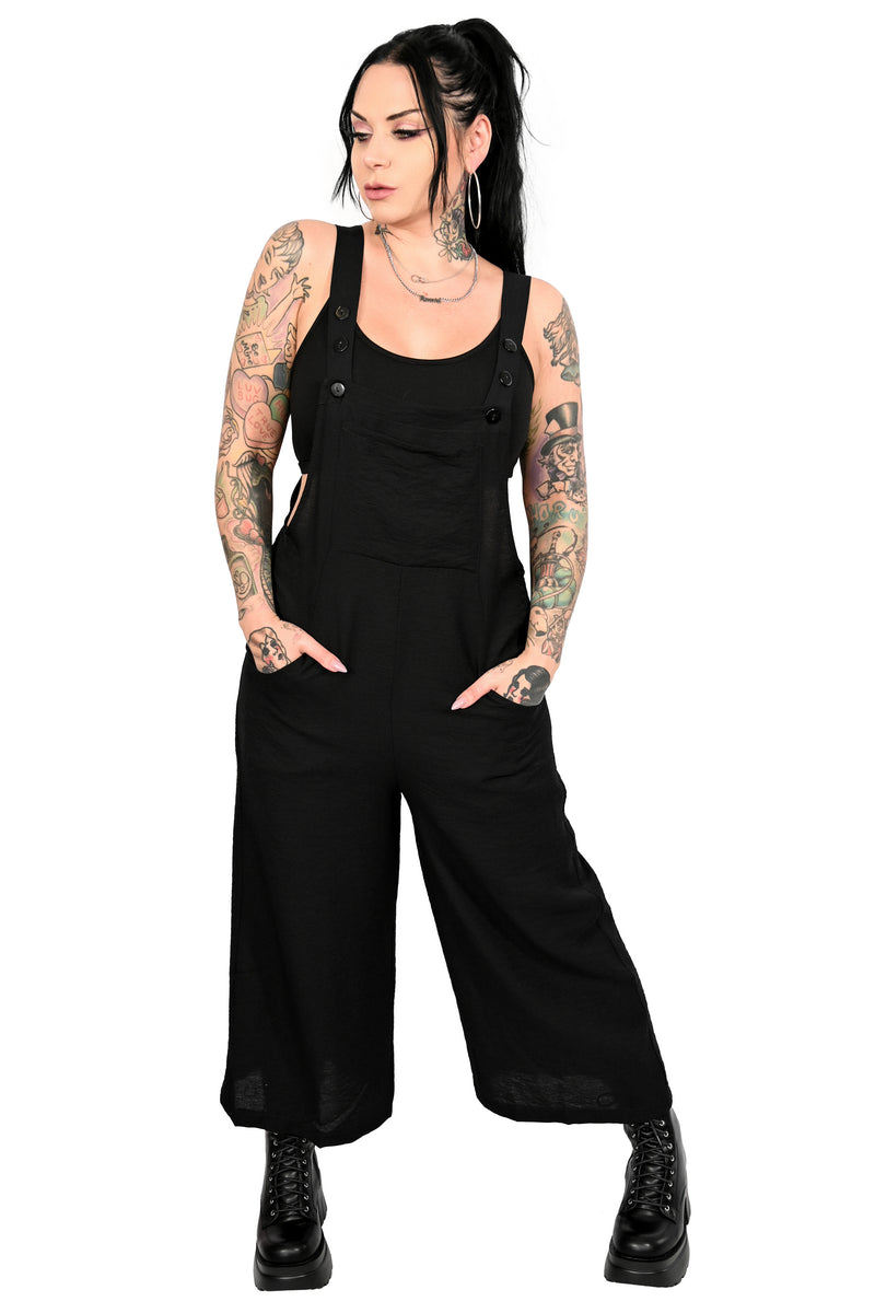 black slouchy wide leg overalls with front and side pockets. adjustable straps with 3 buttons.
