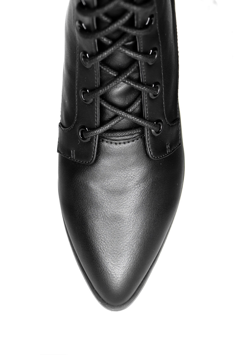 close up of pointed toe on black vegan leather lace up witch boot