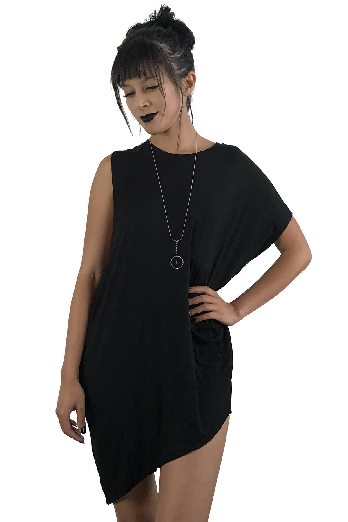 Model is wearing a black longline symmetrical tunic. It has a left sleeve and the right side is sleeveless